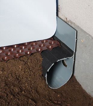 Closeup of a crawl space drainage system installed in Solon Springs
