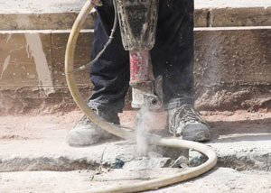 Jackhammering a slab floor in a Hibbing home.