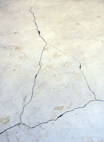 severely cracked, heaving slab floors in a home in Grand Maris
