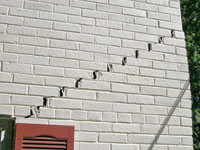 Stair-step cracks showing in a home foundation in Tower
