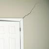 A long drywall crack beginning at the corner of a doorway in an Eden Prairie home.