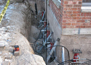 Foundation push piers installed around a house with a foundation settlement issues in Duluth