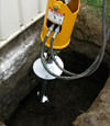 Installing a helical pier during a foundation repair in Eau Claire