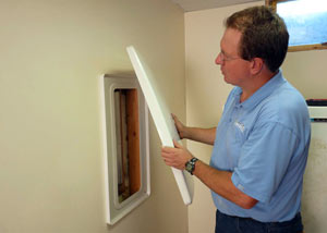 Foundation wall anchor covers installed in a finished basement with a repaired foundation wall in Eau Claire.