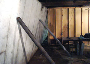 A severely tilting foundation wall propped up by steel beams in Bemidji.