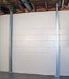 A steel i-beam system installed on a Bemidji foundation wall