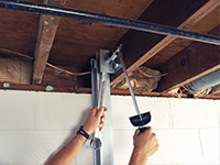 Straightening a foundation wall with the PowerBrace™ i-beam system in a Duluth home.
