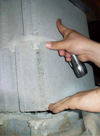 a completely failing concrete crawl space support pillar in Hibbing
