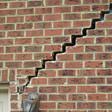 stair step cracking reaching from a window along the foundation wall in Eau Claire