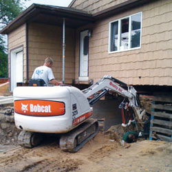 Excavating to expose the foundation walls and footings for a replacement job in Duluth