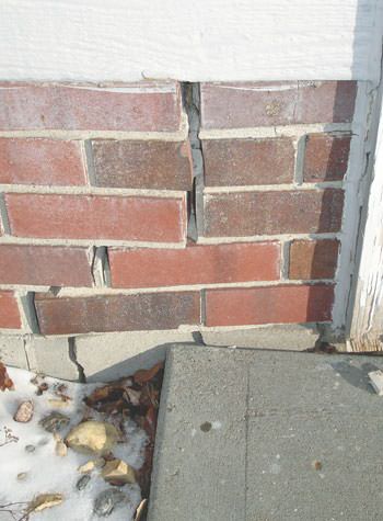 Severe street creep damage to a garage wall outside a Lake Nebagamon home
