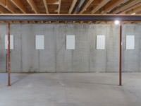 A repaired basement wall with foundation wall anchor covers installed in Duluth.