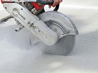 Cutting the driveway for expansion joints during street creep repair in Eau Claire