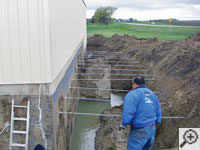 Drilling the hole in the foundation wall for street creep repairs in Eau Claire