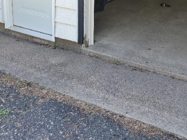 Uneven garage concrete floor before repair in Young America