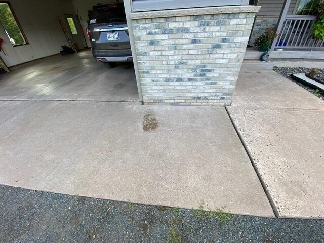 Perfectly stabilized and even concrete driveway slabs in Shell Lake, WI with cracks professionally sealed.