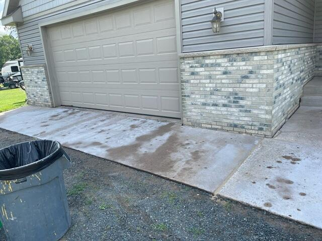 Leveled and restored concrete walkway leading alongside a garage area in Shell Lake, WI after PolyLevel injection.