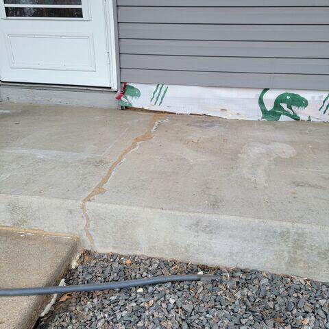 Close-up view of a cracked concrete entrance stoop in Andover, MN sealed with NexusPro and a protection coat.