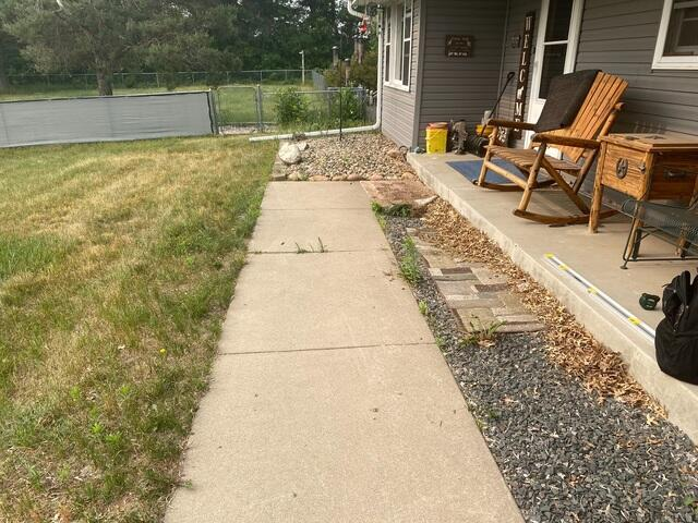 Sinking concrete sidewalk leading to an outdoor kennel area in Andover, MN before professional repair.