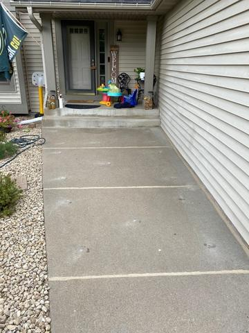 Perfectly leveled and stabilized concrete front walkway in Andover, MN after professional PolyLevel foam injection.