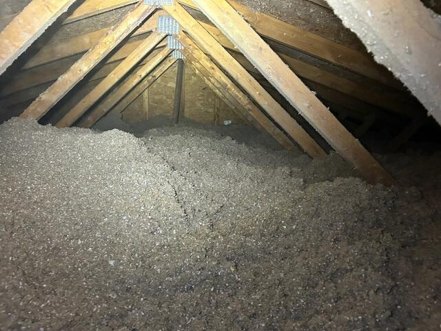 Deep inches of freshly blown high density cellulose insulation inside a home attic in Circle Pines Minnesota