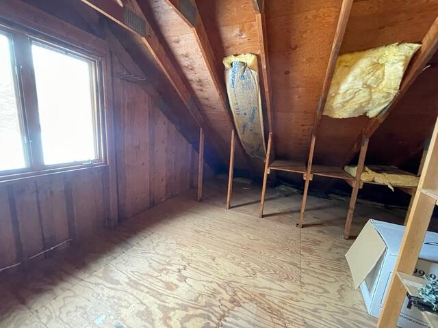 Under-insulated attic before attic insulation installation in Fall Creek WI