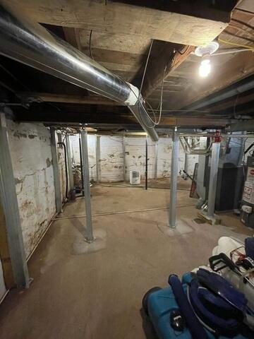Newly installed structural Support Jacks stabilizing a basement main beam in Kettle River, MN.