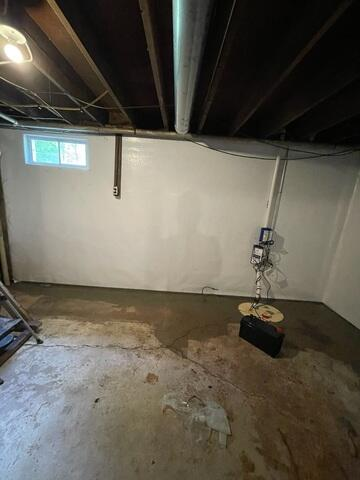An UltraSump system sump pump and CleanSpace wall liner installed in a clean, dry basement in Ashland, WI.