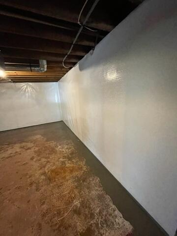 CleanSpace vapor barrier neatly installed on the foundation walls of a basement waterproofing project in Ashland, WI.