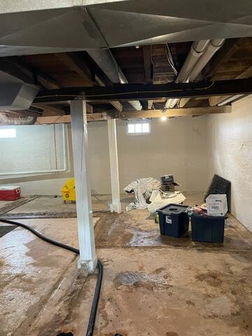 Wide view of an unfinished basement layout during a professional waterproofing system preparation in Kettle River, MN.