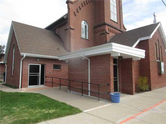 Leveled concrete walkways surrounding the Immaculate Conception Catholic Church building in Butternut WI
