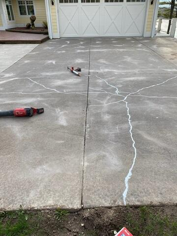 Leveled and stabilized concrete driveway with sealed cracks after PolyLevel injection in Cumberland WI