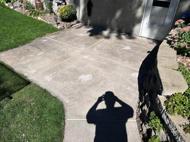 Perfectly leveled concrete backyard patio area sloped away from the house after PolyLevel injection in Duluth, MN.