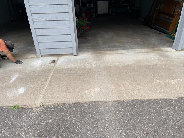 Perfectly leveled and flush concrete garage apron threshold following a PolyLevel foam injection in Hayward, WI.