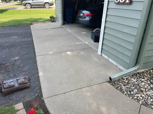 Drilled injection holes along a curved concrete front walkway during PolyLevel repair in Sauk Rapids MN