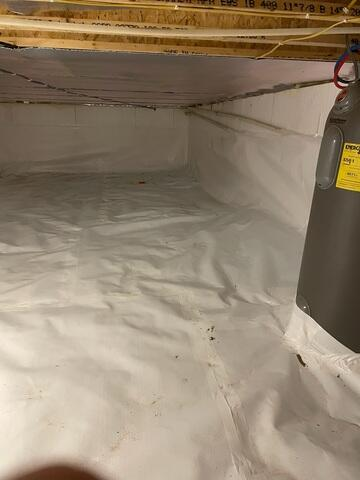 Heavy duty plastic liner anchored neatly up a foundation wall during crawl space repair in Spooner Wisconsin