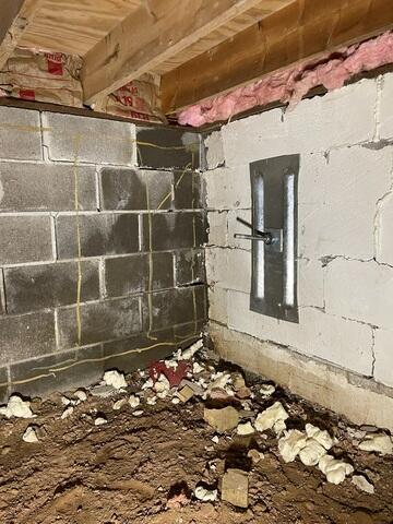 Bowing and cracked concrete block foundation wall inside a crawl space before repair in Radisson Wisconsin