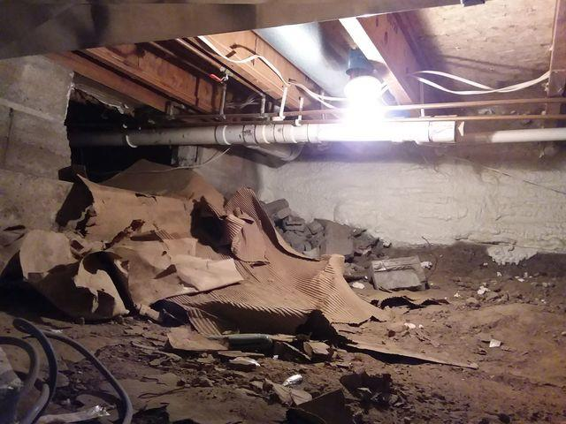 Crawl space with exposed earth before encapsulation in Cloquet, MN