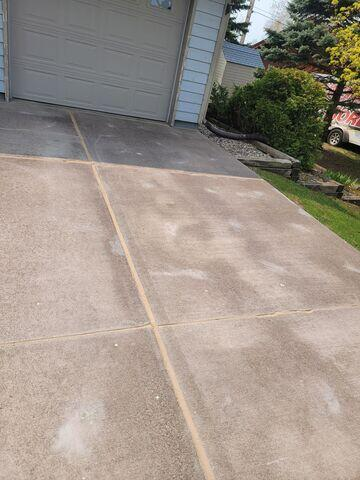 Uneven concrete driveway panels before lifting repair in Superior WI