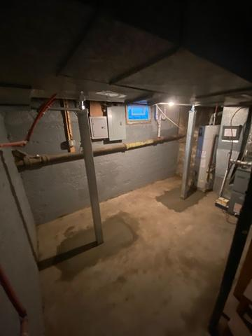SmartJack heavy duty steel support columns installed to permanently stabilize sagging basement beams in Dresser Wisconsin