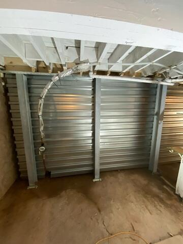 Completed foundation repair using the EverBrace system with steel panels in an Ashland WI basement