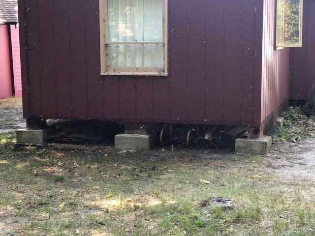 Exterior view of an unsupported crawl space foundation in Cass Lake MN before repair