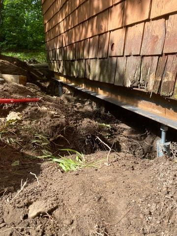 Helical piers installed along the exterior of a settling home in Chetek WI