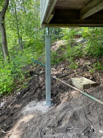 Heavy-duty SmartJack steel post supporting a lakeside cabin in Chetek WI