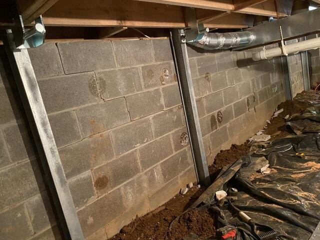 Concrete block foundation wall showing signs of strain and moisture exposure before repair in Hayward Wisconsin