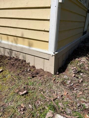 Exterior view of a home's skirting and foundation in Herbster WI needing repair