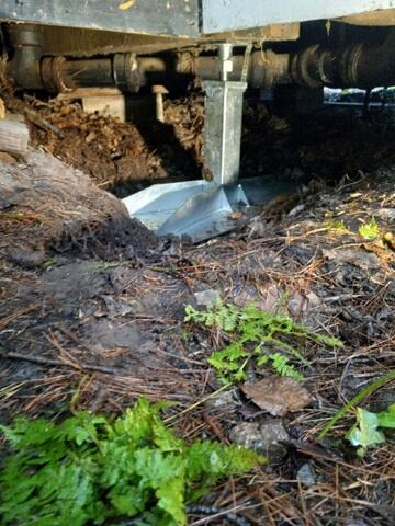 Close-up of a SmartJack foundation support base beneath a cabin in La Pointe WI