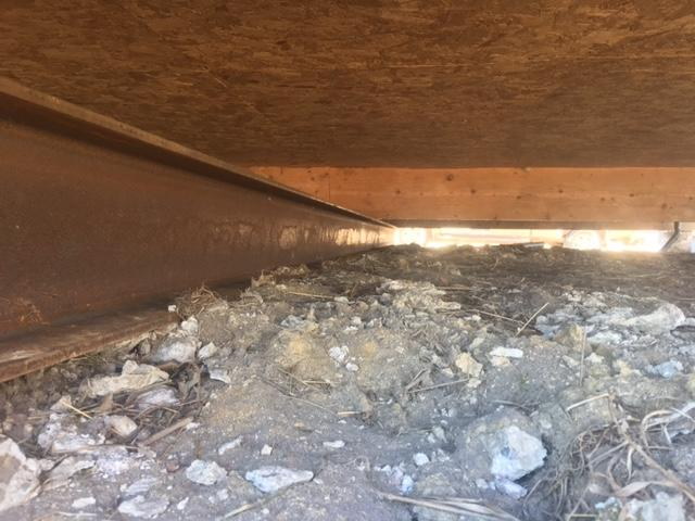 Heavy duty steel I beam installed on top of deep helical piers to support a cabin foundation in Palisade Minnesota