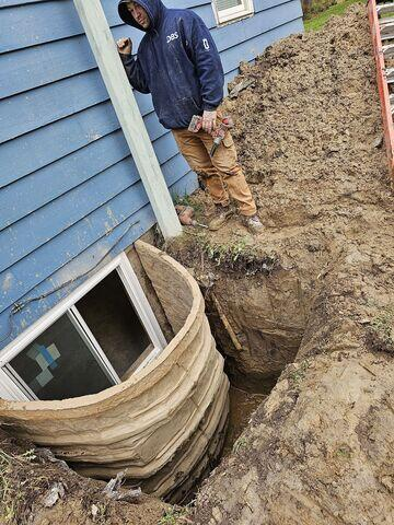 Exterior view of an egress window installation process in Remer MN