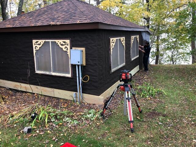 Exterior view of a newly constructed dark colored lakeside cabin utilizing helical piers in Moose Lake Minnesota